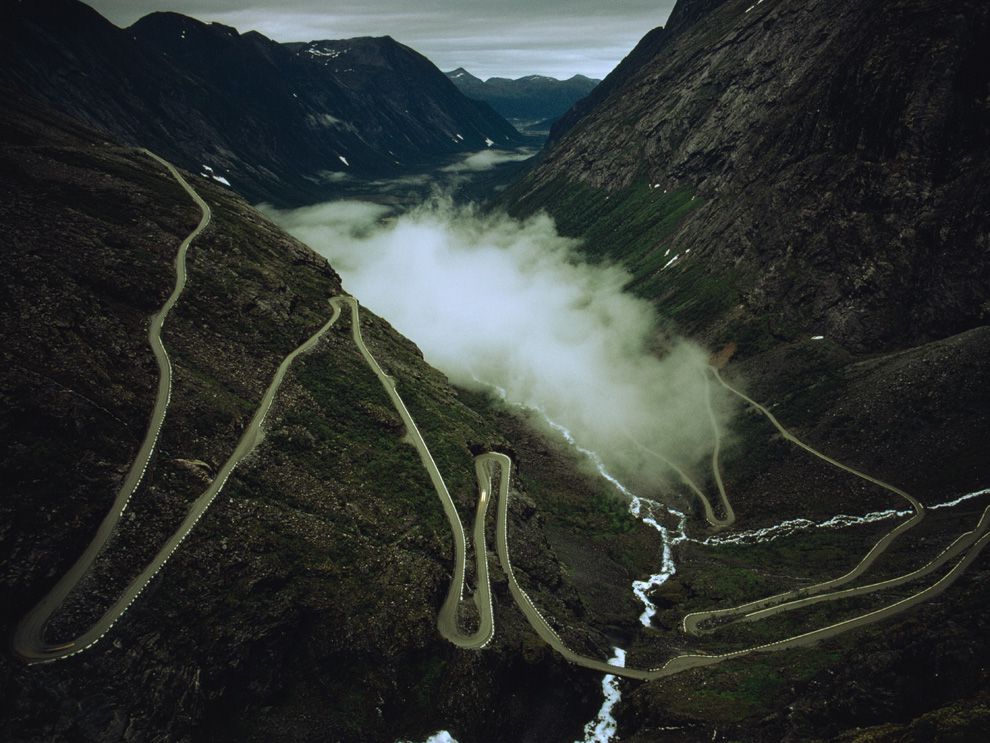 Fog settles in a valley near Andalsnes, Norway. Valley fog accumulates as air is cooled on mountaintops. The cold, dense air then moves down into the valley, where it builds up layers of fog.