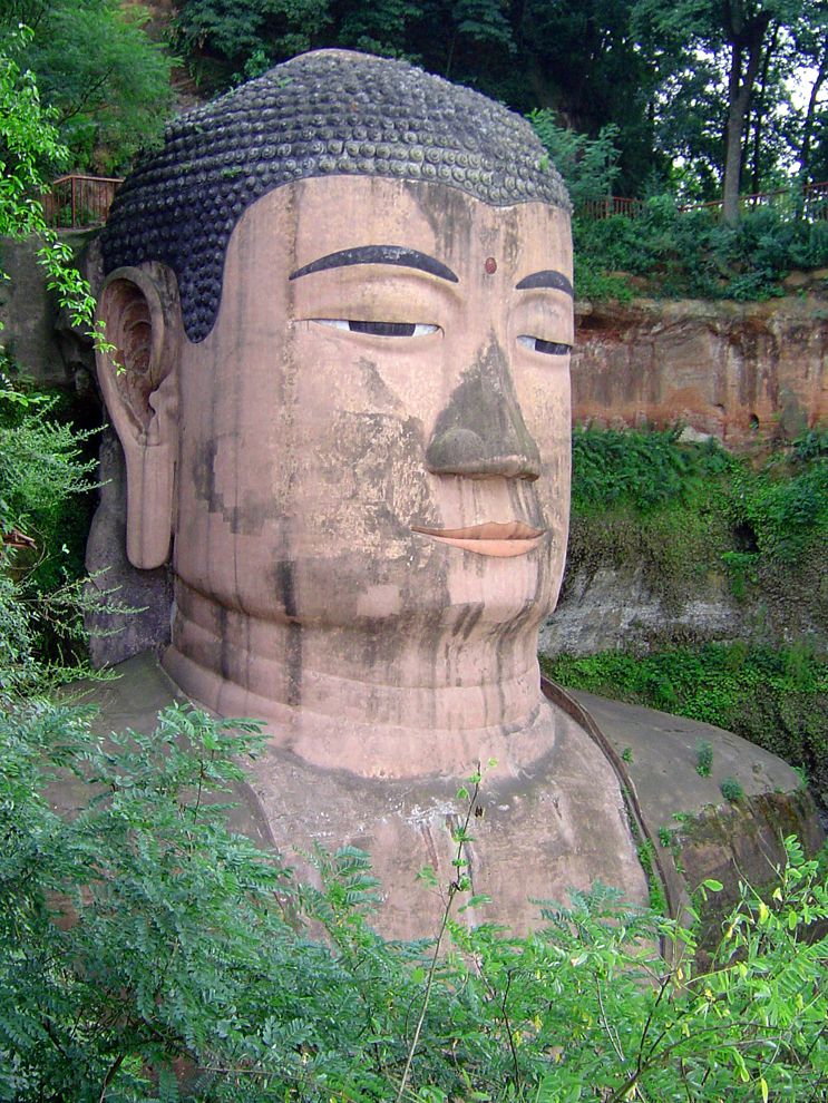 The Leshan Giant Buddha, in Sichuan, China, is the largest Buddha in the world. The statue is carved directly into the mountainside and measures 71 meters (233 feet) tall. The Leshan Giant Buddha is one of the most visible symbols of weathering caused by pollution. Nearby industrial development and a stream of tourists arriving by bus have caused chemicals in the air to corrode, or wear away, the delicate stone of the carving.