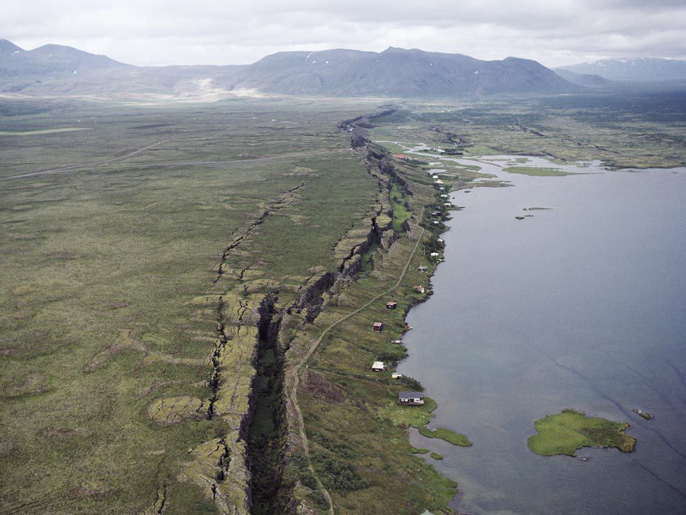 This rift valley in Iceland stretches along the Mid-Atlantic Ridge, where the North American and Eurasian tectonic plates are pulling apart from each other. The body of water to the right, Lake Thingvallavatn, is the largest lake in Iceland and was formed as a result of volcanic activity around the rift. The Thingvellir rift grows about 1 centimeter (.4 inch) every year.
