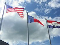 Photograph of flags blowing in the wind.