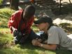 Picture of Lynn Johnson working with a student during Photo Camp Haiti