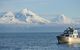 NOAA ship in the forefront of a large mountain in Alaska