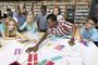 Students engaged in learning over a large map