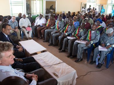 Local authorities of Boffa, Guinea, meet with an Ambassador of the Kingdom of the Netherlands, the Special Representative of the Secretary-General and Head of the United Nations Mission for Ebola Emergency Response, and others in February 2015.
