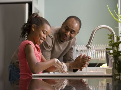 2009Dawn ArlottaThis African-American father was shown in the process of teaching his young daughter how to properly wash her hands at their kitchen sink, briskly rubbing her soapy hands together under fresh running tap water, in order to remove germs, and contaminants, thereby, reducing the spread of pathogens, and the ingestion of environmental toxins. Children are taught to recite the Happy Birthday song, during hand washing, allotting enough time to completely clean their hands.<b><u>Keywords</u></b>: Prevention; Hand washing; Children; Kids; Contaminants; Germs; H1N1; Skin; Dermal Contamination