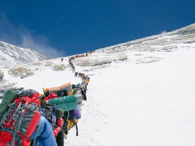 Mount Everest is becoming increasingly crowded as climbers flock to summit the world's highest point. This line of climbers moves single file up the Lhotse Face.