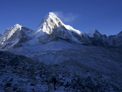 The peak of Mount Everest, highest point on Earth, illuminated by the sun.