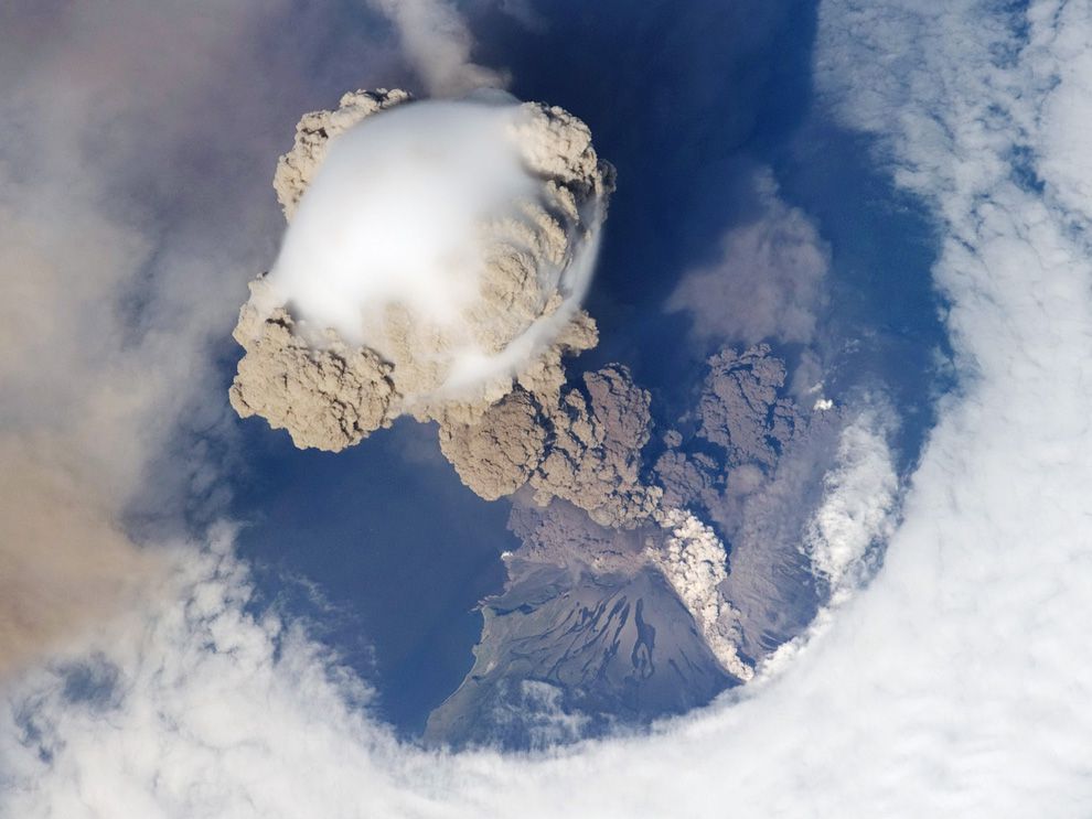 How do volcanoes affect the Earth's atmosphere?