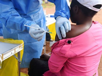 On August 18, 2018, a health worker administers the Ebola vaccine to a woman recently in contact with someone infected by the disease Ebola in the Democratic Republic of Congo.